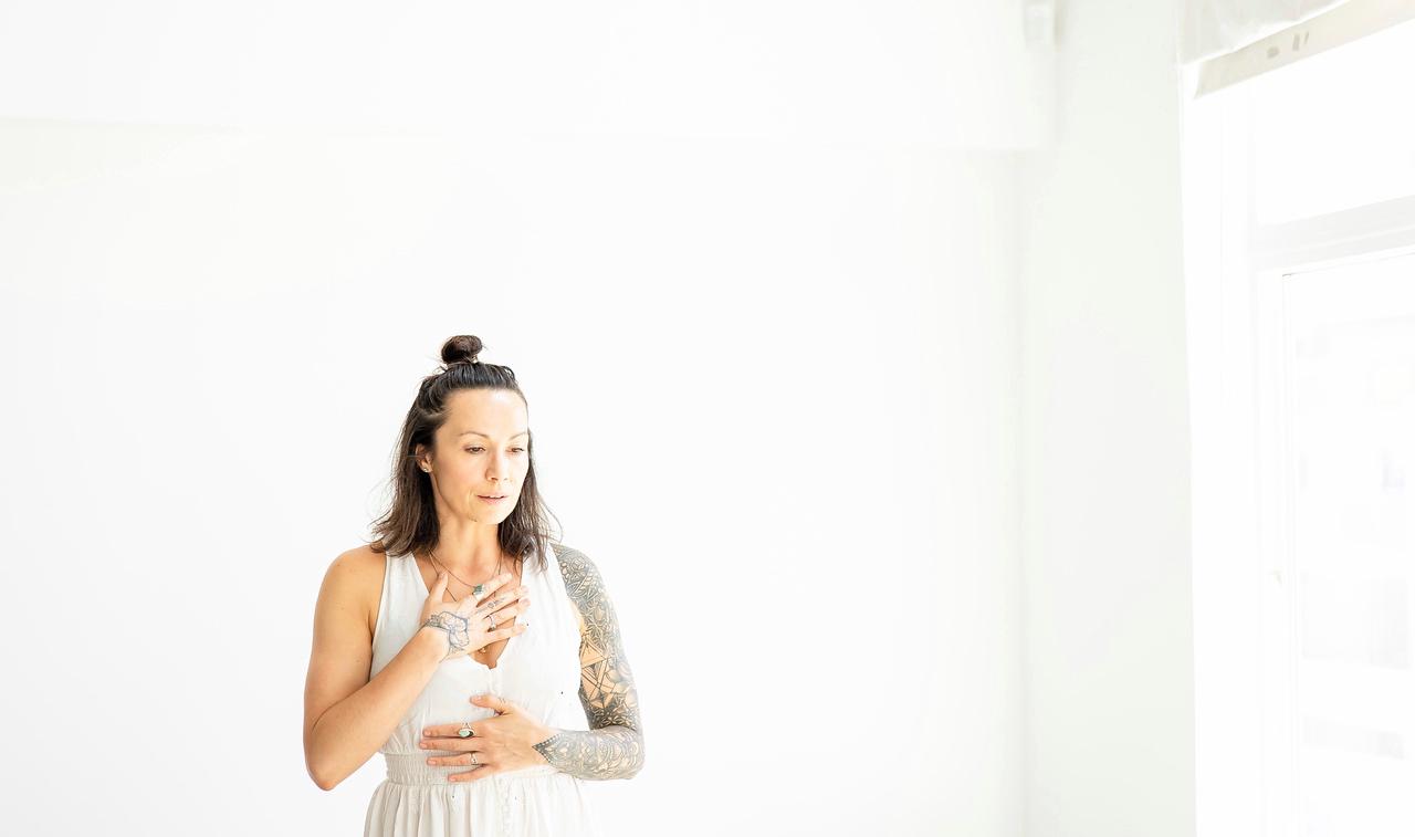 Woman practicing breathwork with hand on chest for nervous system regulation